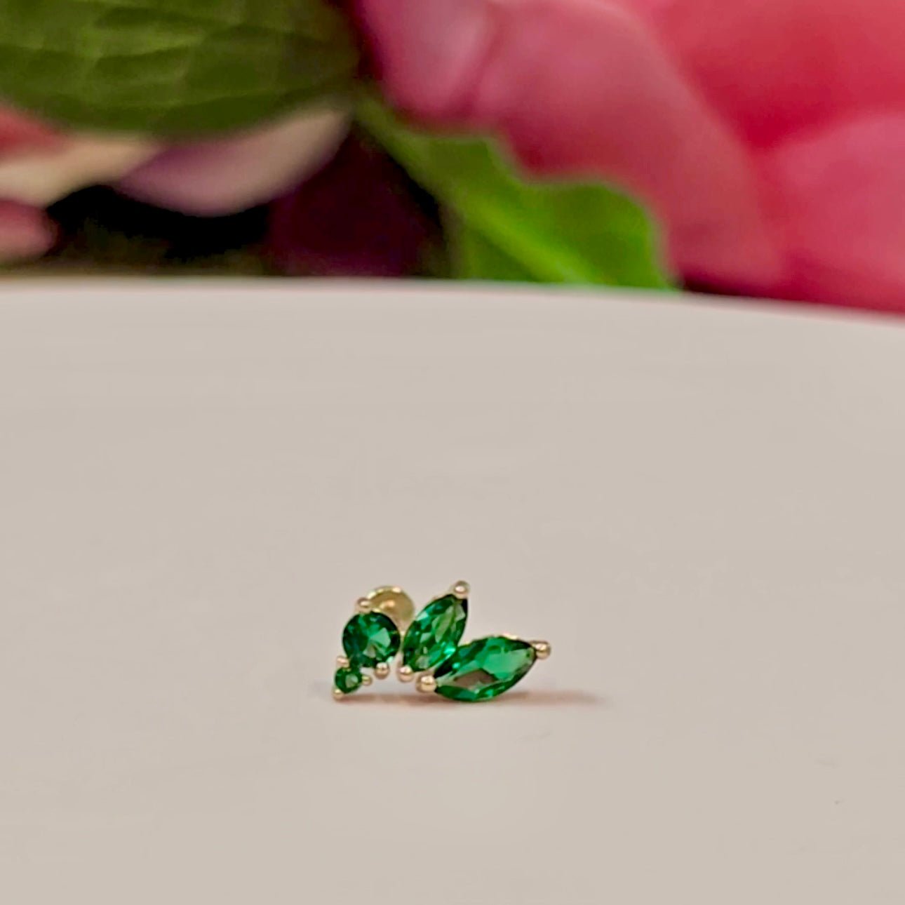 a close up of a pair of earrings on a table