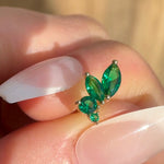 a close up of a person's hand with a green ring