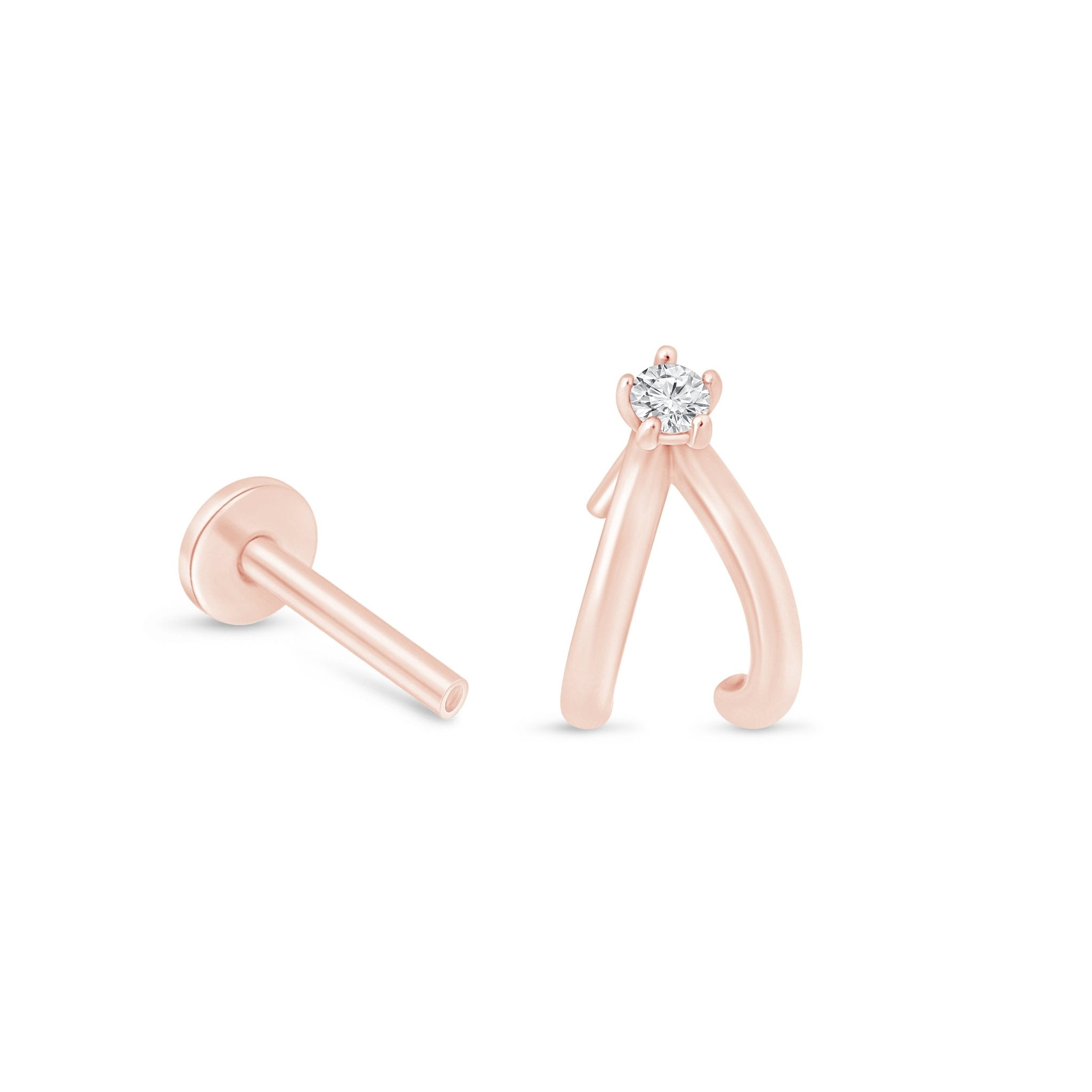 a pair of pink gold earrings with a single diamond