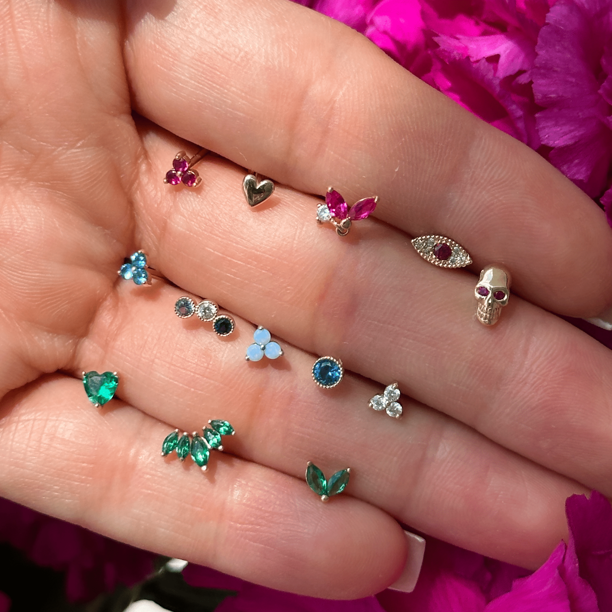 a person holding a bunch of different colored stones