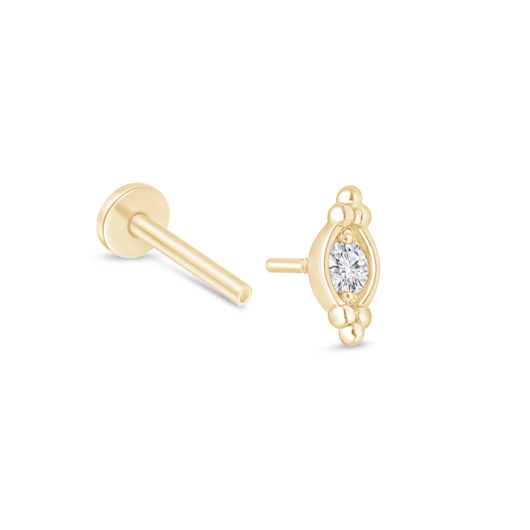 a pair of gold earrings with a diamond