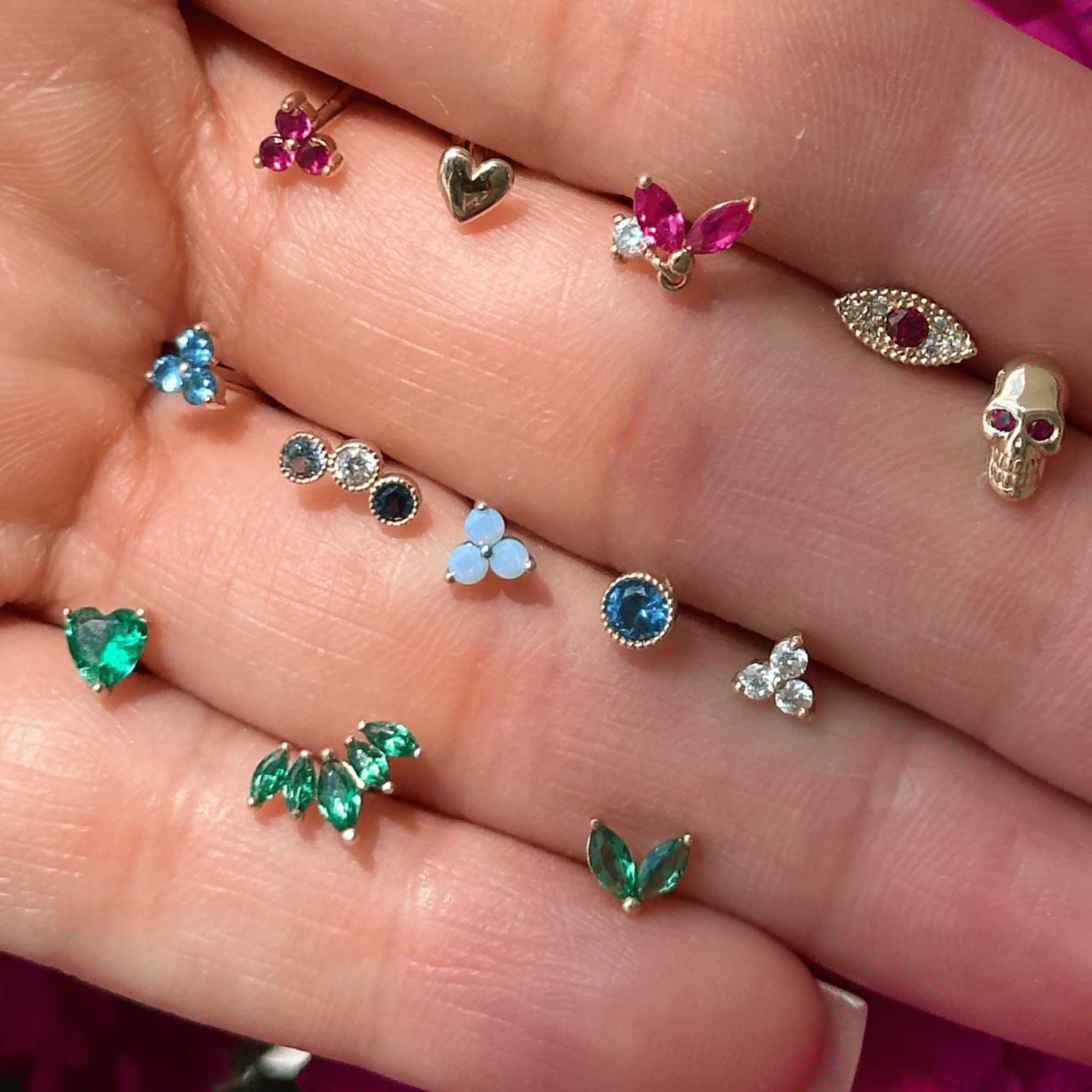 a person holding a bunch of different colored stones