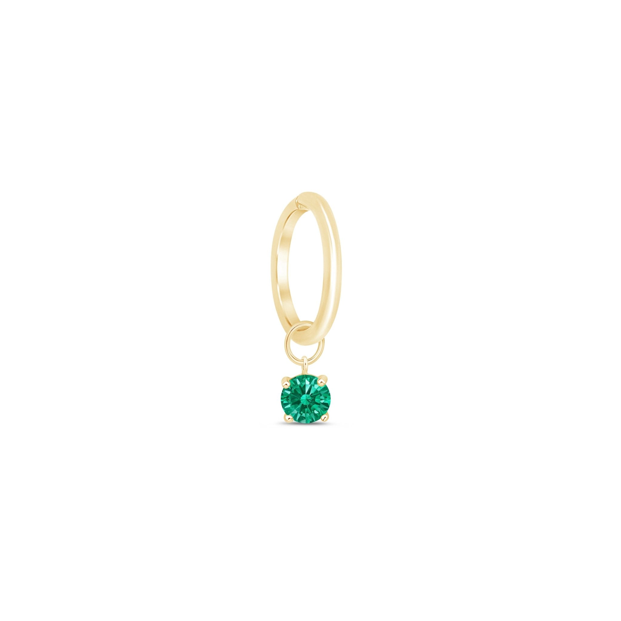 a gold ring with a green stone in the middle