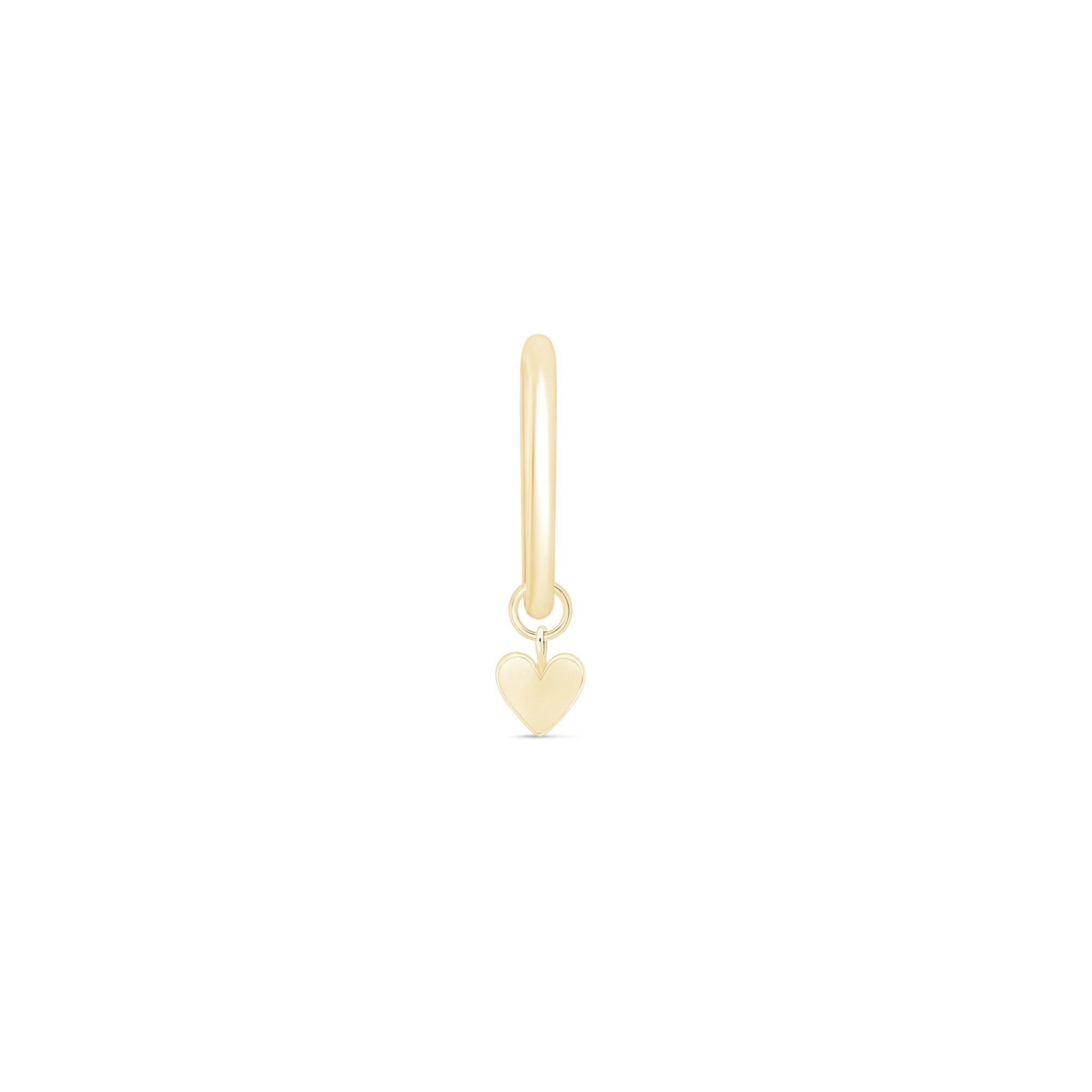 a gold heart charm on a white background