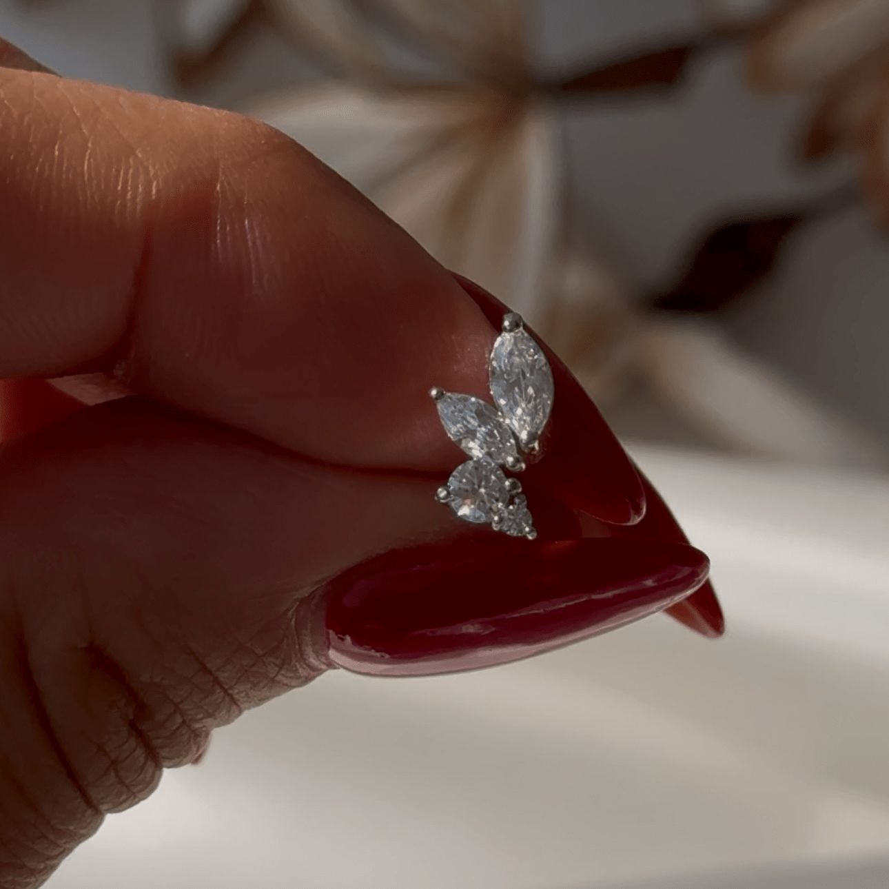 a woman's hand holding a diamond ring