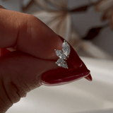 a woman's hand holding a diamond ring