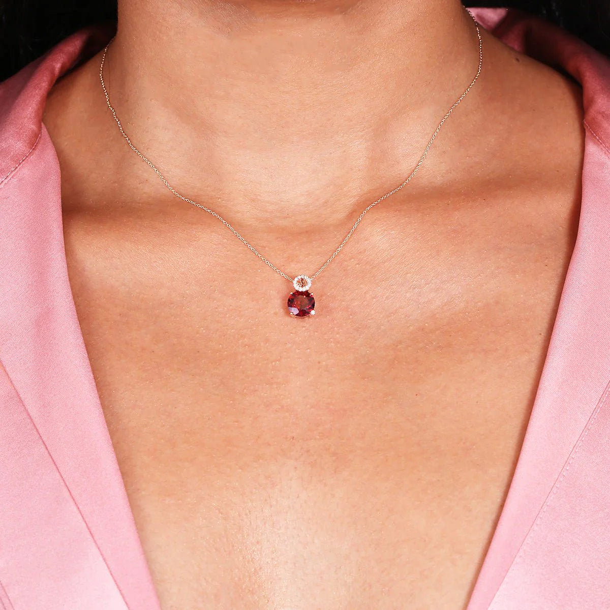 A woman wearing the Stacked Diamond and Garnet Solitaire Pendant Necklace