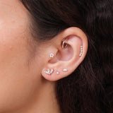 a close up of a person wearing a pair of ear piercings