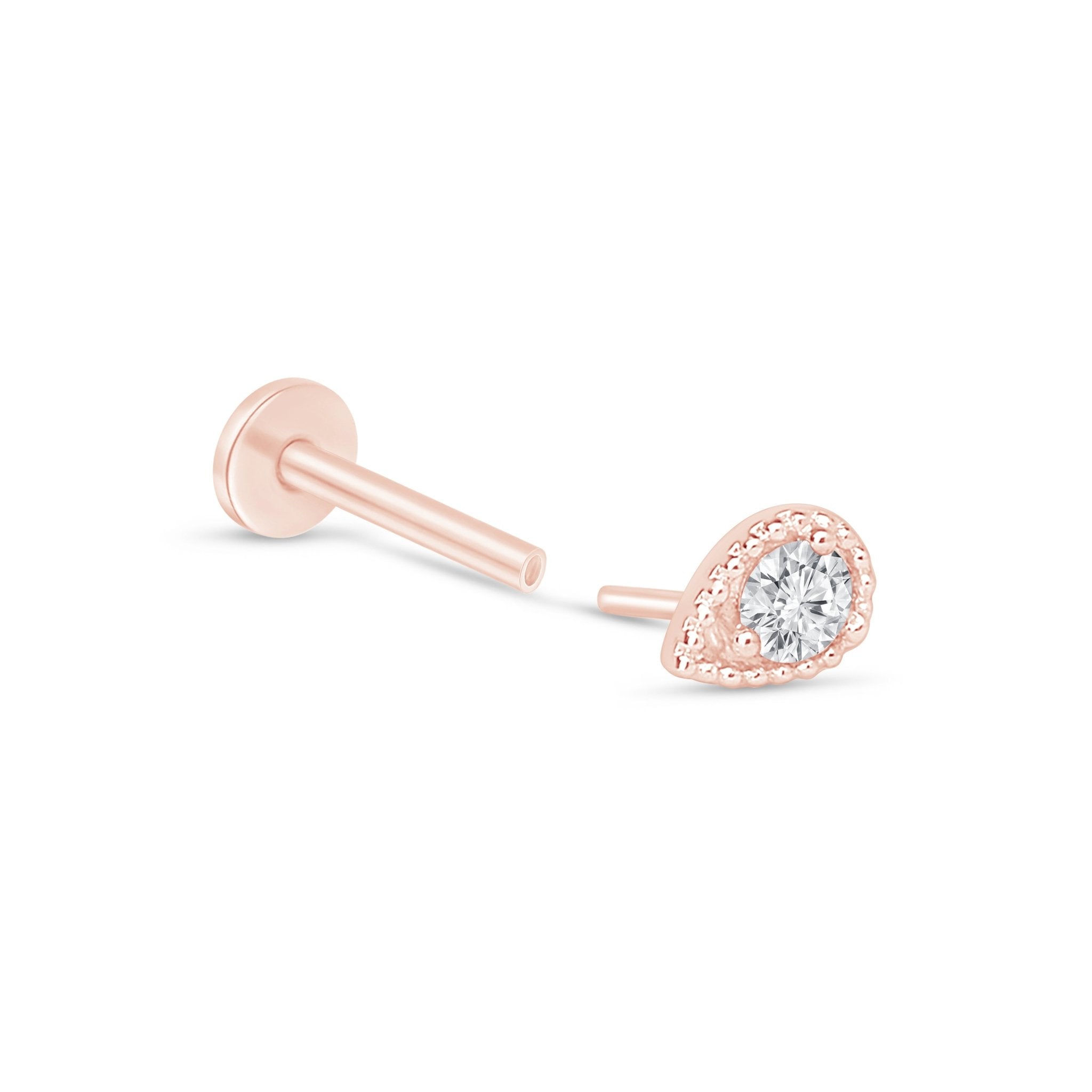 a pair of rose gold earrings with a diamond