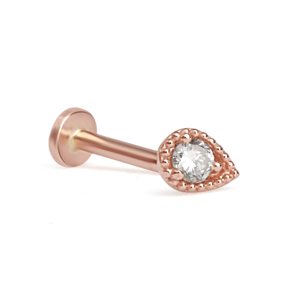 a rose gold nose piercing with a crystal stone