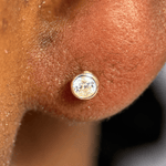 a close up of a person's ear with a diamond in it