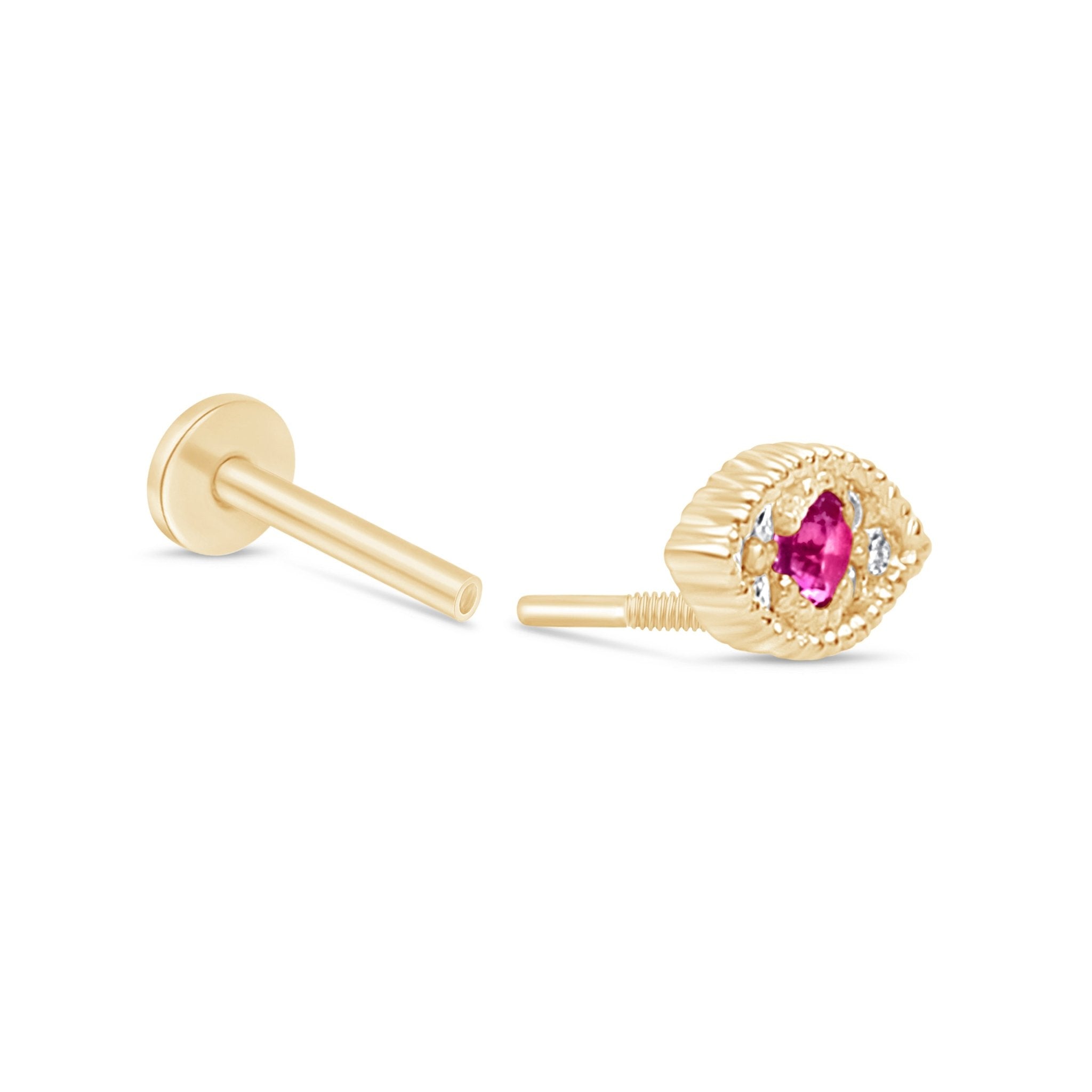 a pair of gold earrings with a pink stone