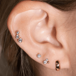 a close up of a person wearing a pair of ear piercings