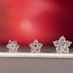 a pair of diamond earrings sitting on top of a table