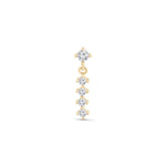 a gold earring with three diamonds on a white background