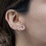 a close up of a person wearing a pair of ear piercings