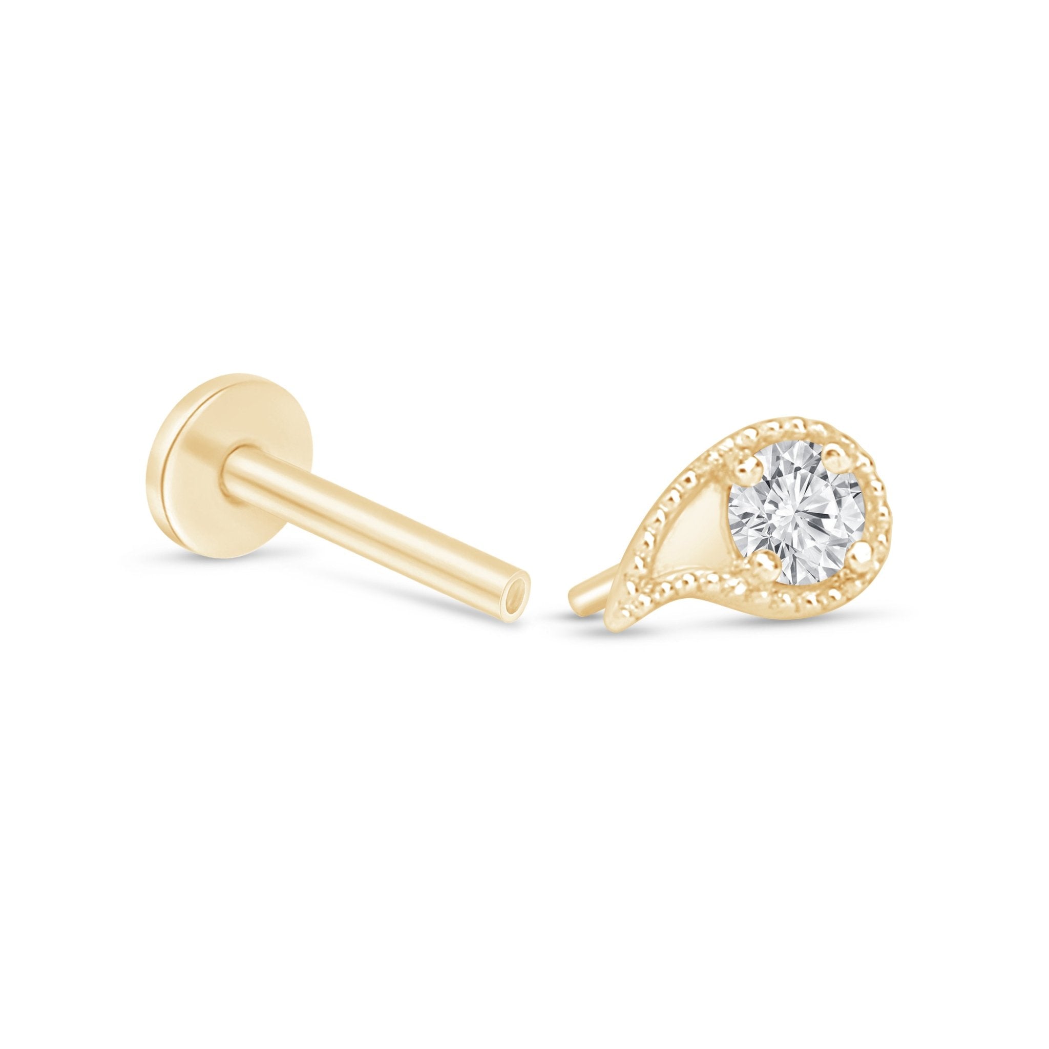 a pair of yellow gold earrings with a diamond