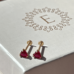 a white box with a pair of earrings on it