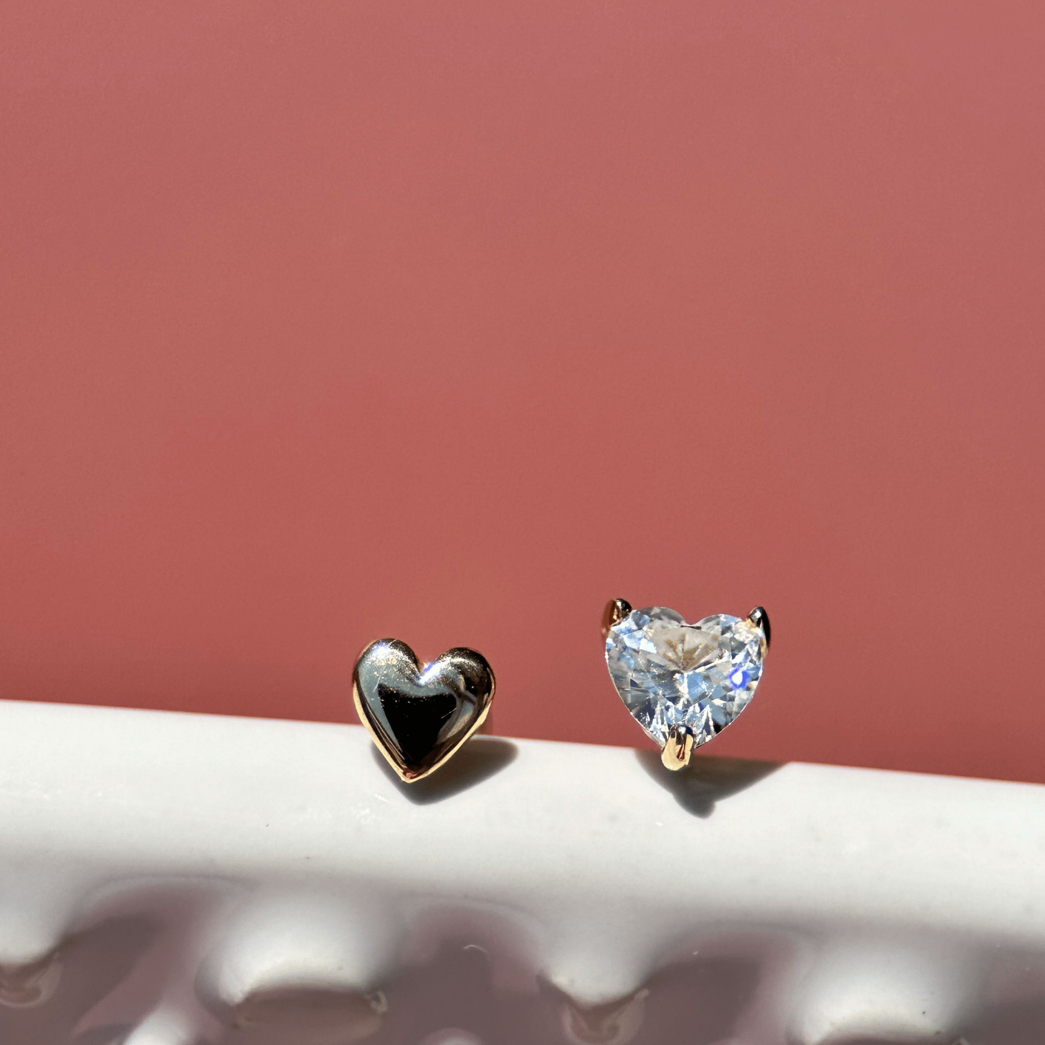 a pair of diamond earrings sitting on top of a table