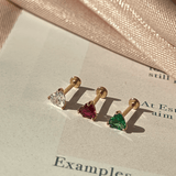 a pair of earrings sitting on top of a piece of paper