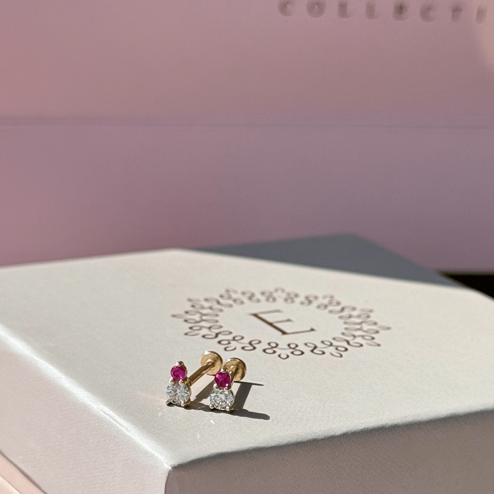 a white box sitting on top of a pink table