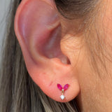 a close up of a person's ear with a pink flower on it