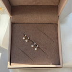 a box with a pair of pearls in it