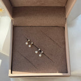 a box with a pair of pearls in it