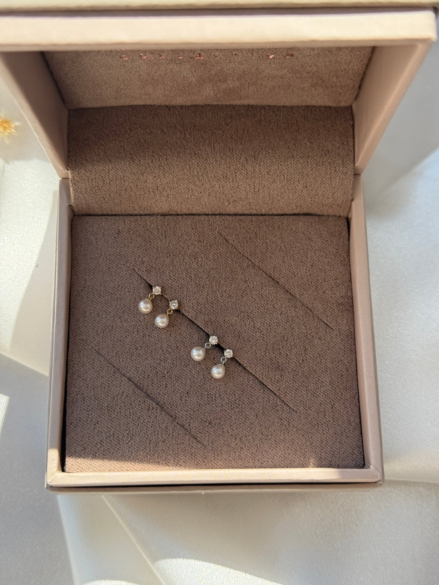 a box with a pair of pearls in it