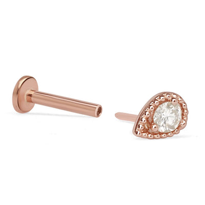 a pair of rose gold earrings with a white diamond