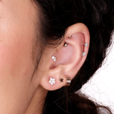 a close up of a person wearing a pair of ear piercings