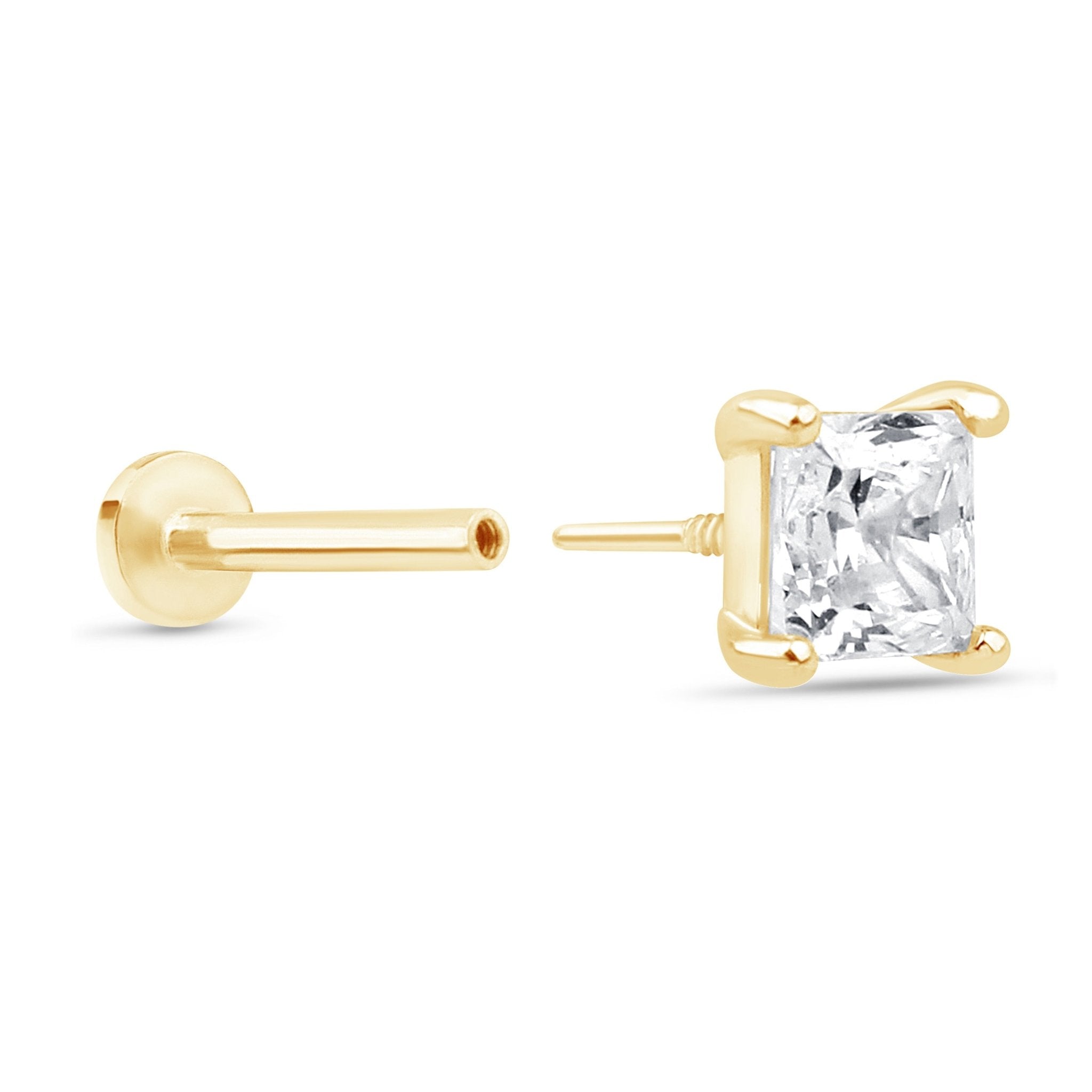 a pair of yellow gold earrings with a princess cut diamond