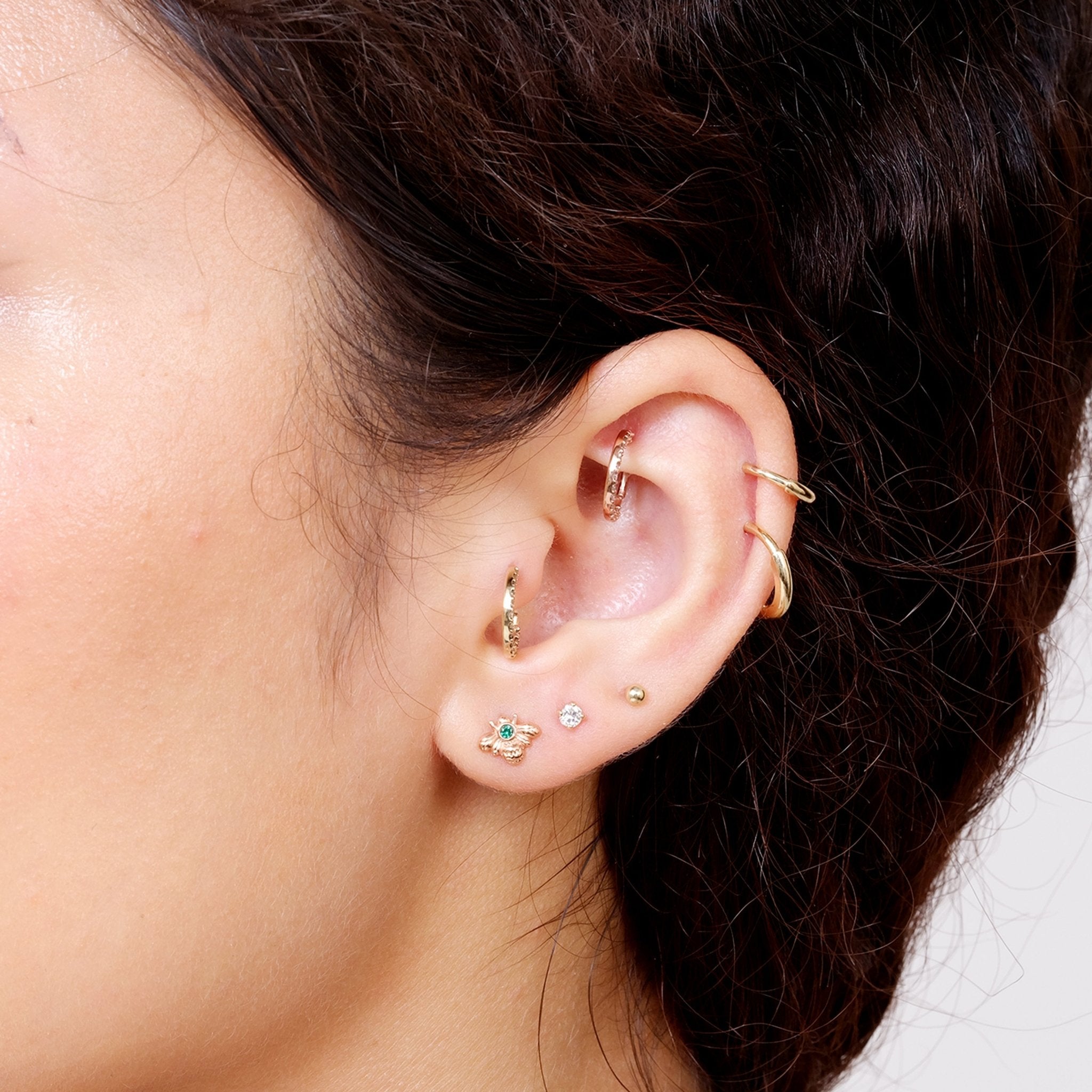 a close up of a person wearing a pair of ear piercings