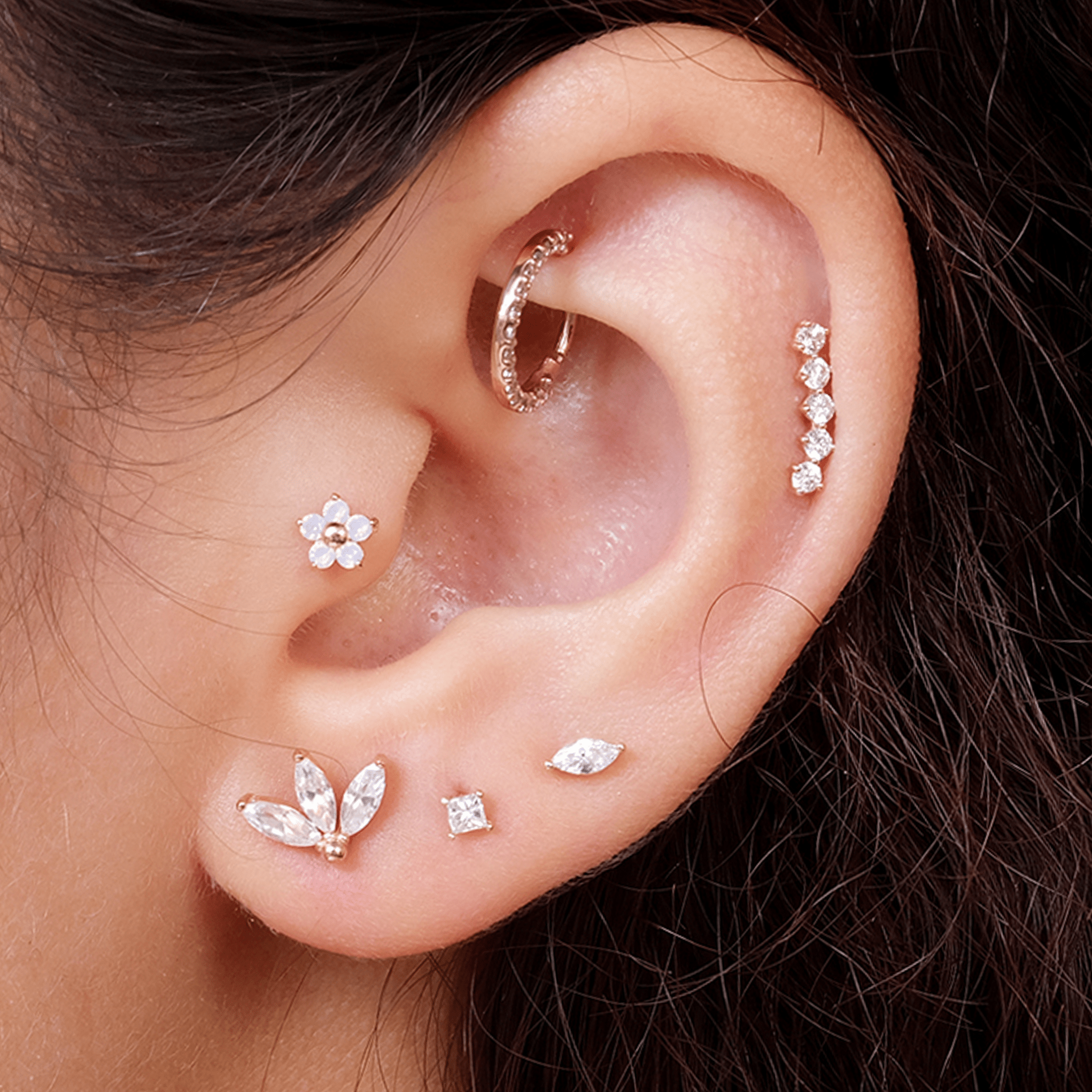 a close up of a person wearing a pair of ear piercings