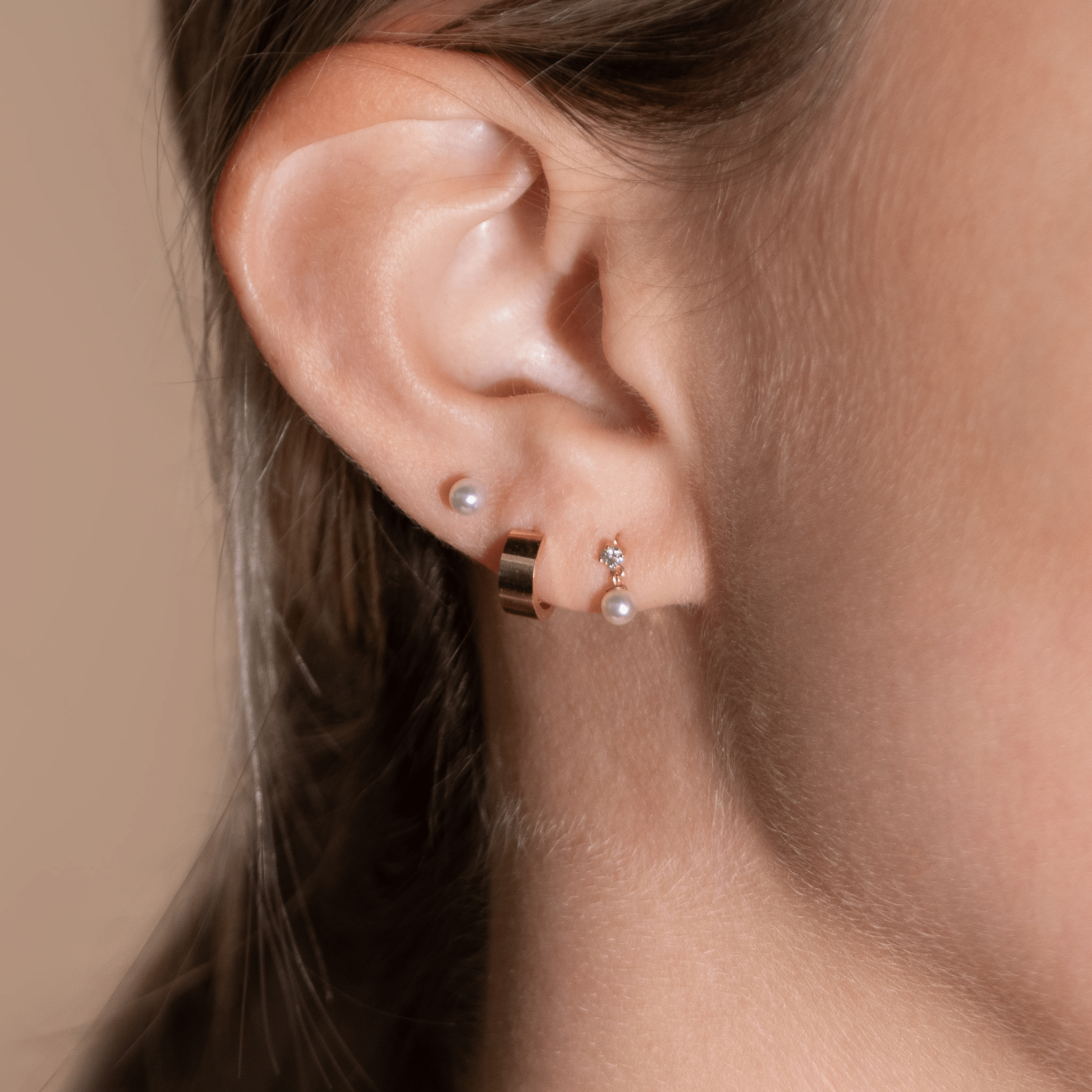 a close up of a person wearing a pair of earrings