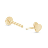 a pair of gold heart earrings on a white background