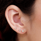 a close up of a person wearing a pair of ear piercings