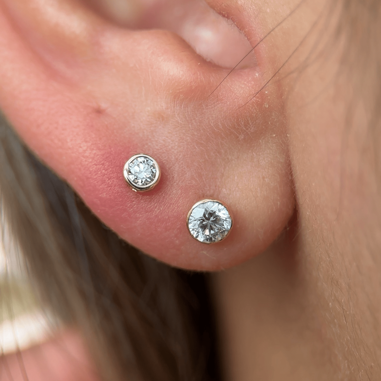 a close up of a person wearing a pair of ear piercings