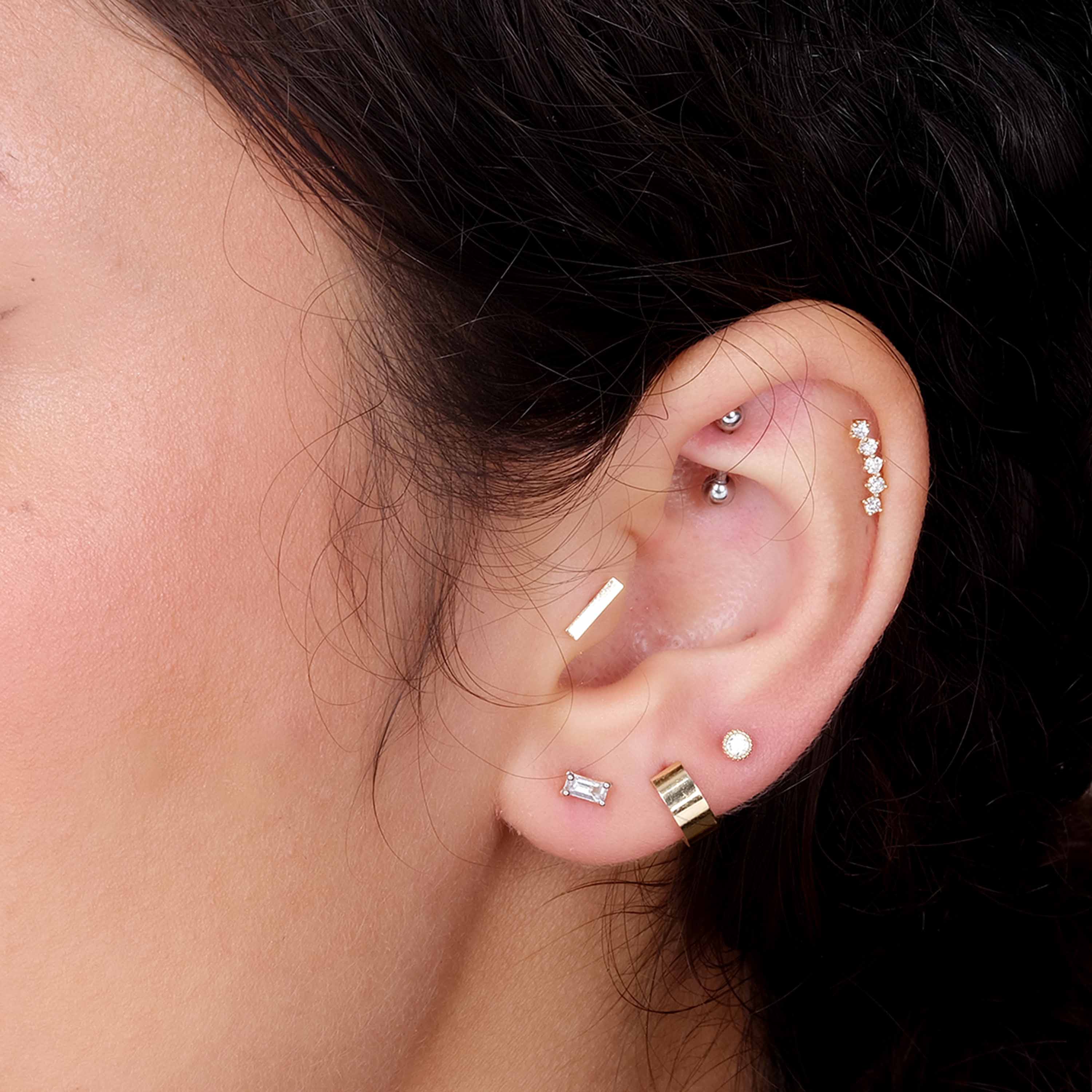 a close up of a person wearing a pair of ear piercings