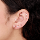 a close up of a person wearing a pair of ear piercings