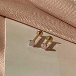 a pair of earrings sitting on top of a table