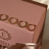 a pink box with three rings inside of it