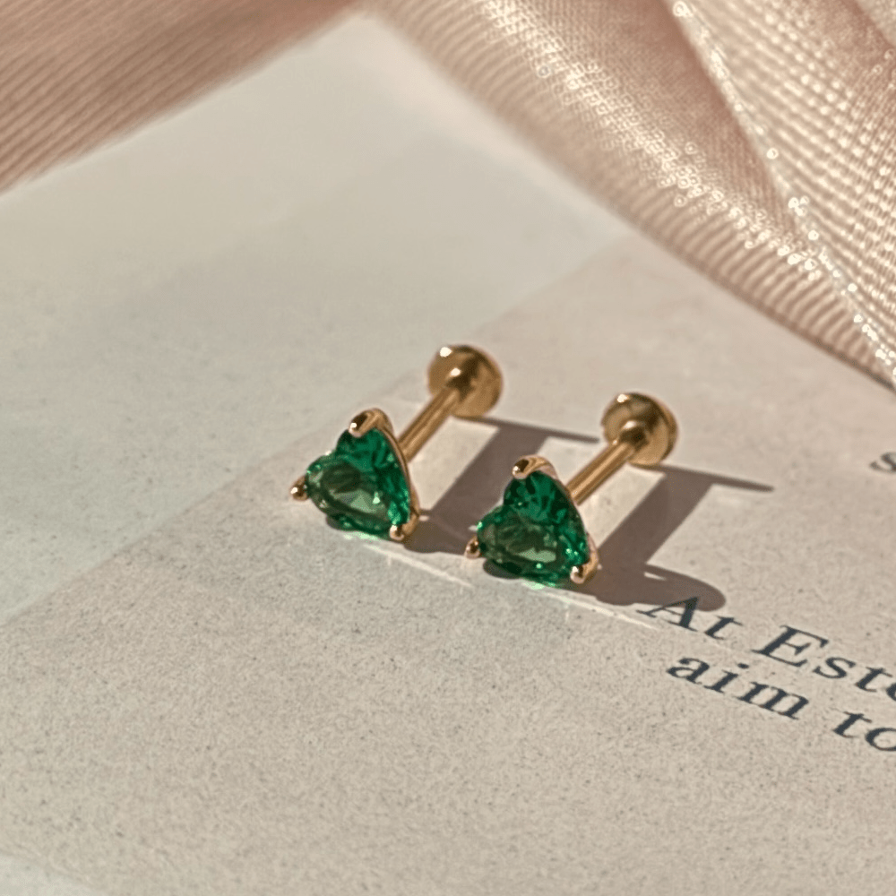 a pair of earrings sitting on top of a piece of paper