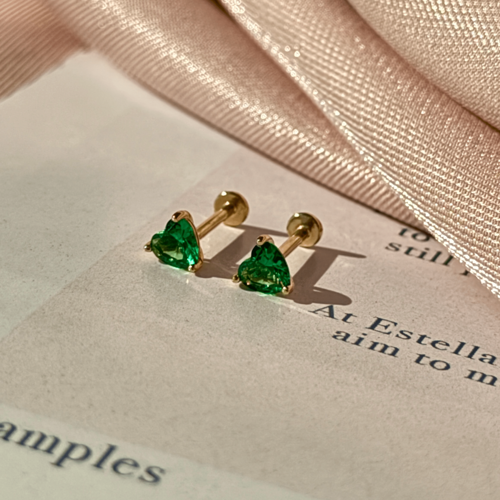 a pair of earrings sitting on top of a piece of paper