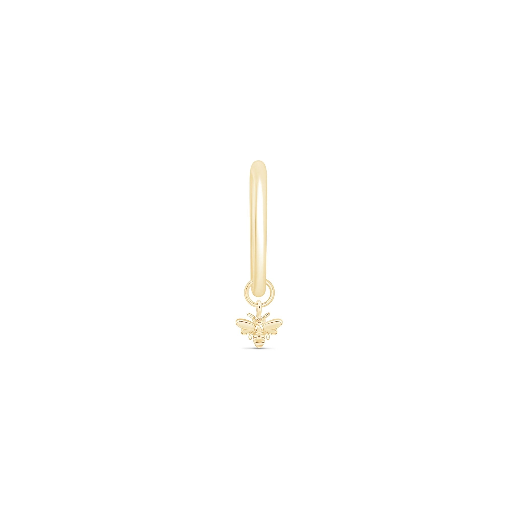 a gold charm with a bee on it