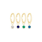 three pairs of gold hoop earrings with different colored stones