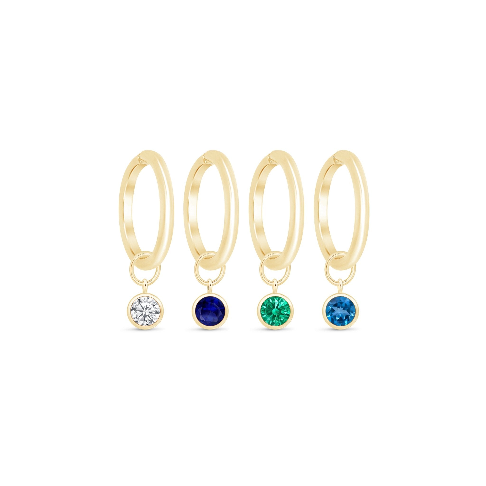 three pairs of gold hoop earrings with different colored stones