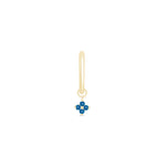 a gold earring with a blue flower on it