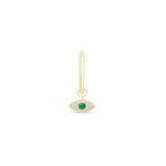 a gold earring with an evil eye charm