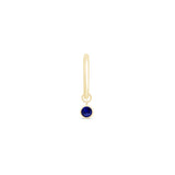 a gold nose ring with a blue stone